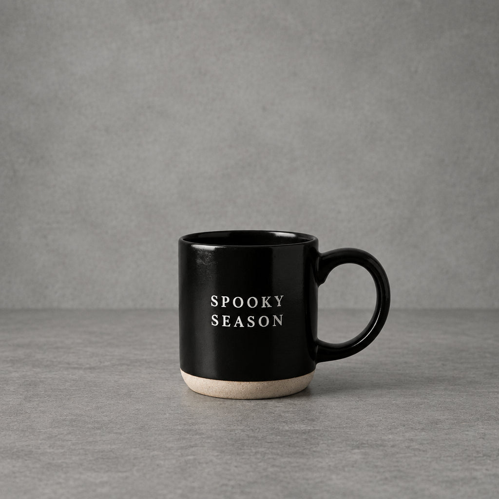 Impish Greetings black stoneware coffee mug with Spooky Season text in white, featuring a natural base.