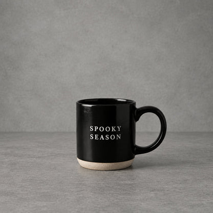 Impish Greetings black stoneware coffee mug with Spooky Season text in white, featuring a natural base.