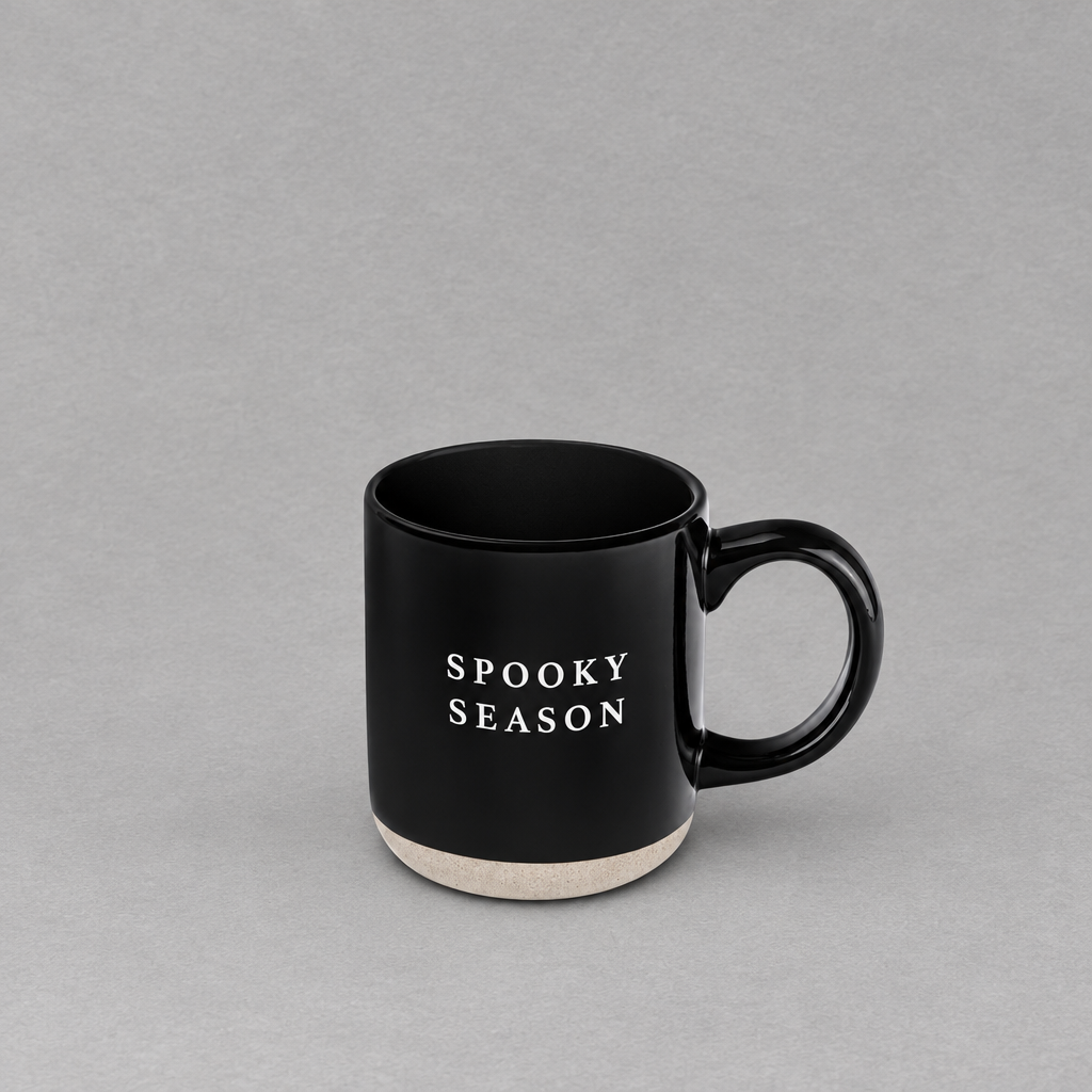 Impish Greetings black stoneware coffee mug with Spooky Season text and a natural speckled base