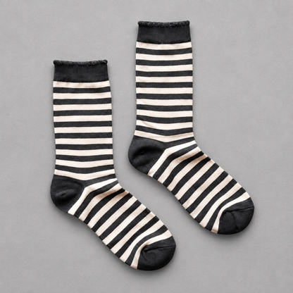 Impish Greetings black and white striped crew socks with scalloped edges for a festive Halloween look.