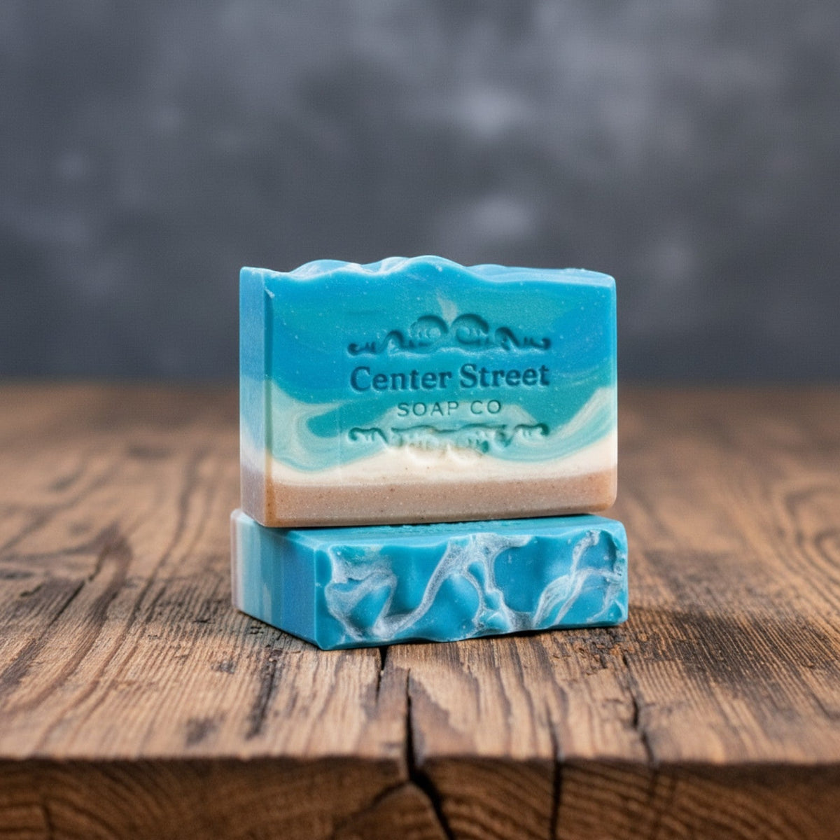 Impish Greetings Summer Cottage artisan soap bars featuring blue and white swirls on a rustic wooden surface