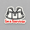 Impish Greetings I'm a Survivor vinyl sticker featuring a black and white playground merry-go-round illustration.