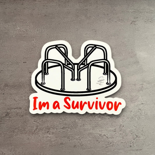 Impish Greetings I’m a Survivor vinyl sticker featuring a playground merry-go-round illustration on wood background.