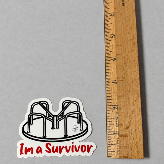 Impish Greetings I’m a Survivor vinyl sticker featuring a black and white playground merry-go-round next to a ruler.