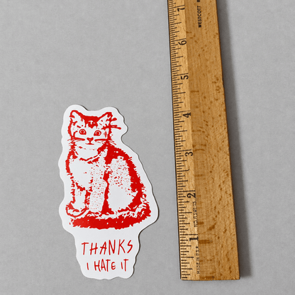 Impish Greetings Thanks, I Hate It vinyl sticker featuring a red cat illustration next to a wooden ruler for scale.