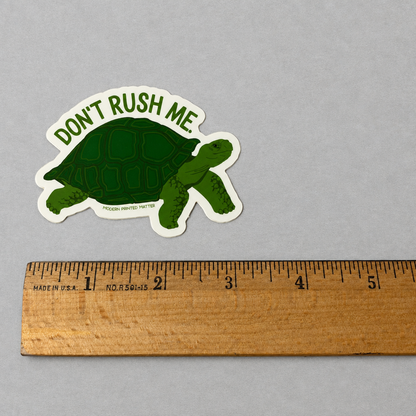 Impish Greetings Don't Rush Me sticker featuring a green tortoise illustration with text on a white background.