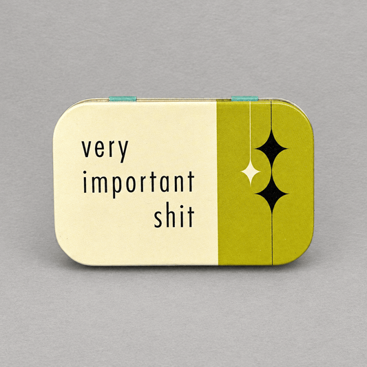Impish Greetings Very Important Shit stash tin in cream and olive green with a hinged lid and retro star design.