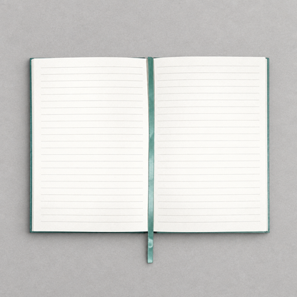 Impish Greetings A5 vintage notebook open to ivory lined pages with a matching teal ribbon bookmark
