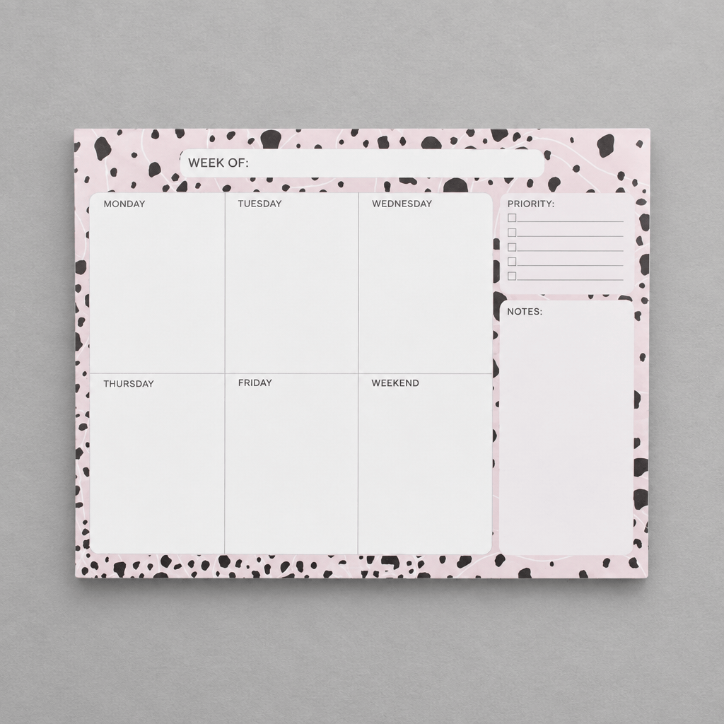Impish Greetings Week of Productivity notepad with a pink and black dalmatian print border on a grey background.