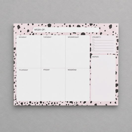 Impish Greetings Week of Productivity notepad with a pink and black dalmatian print border on a grey background.