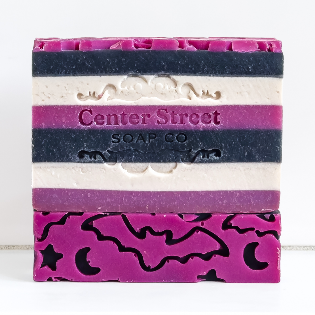 Impish Greetings Witching Hour artisan soap bar with purple, black, and white stripes and bat and moon cutouts.