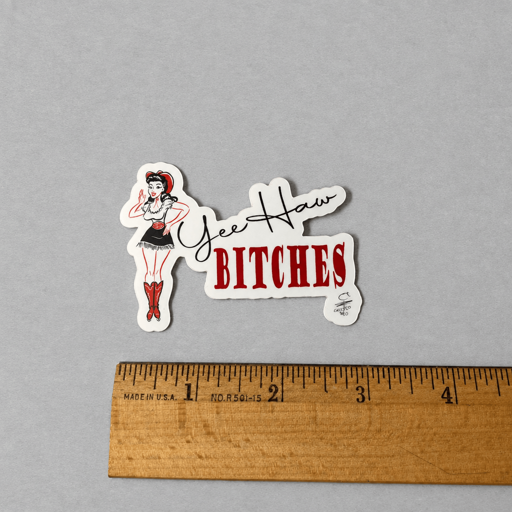 Impish Greetings Yee Haw Bitches vinyl sticker featuring a pin-up cowgirl illustration on a grey background.
