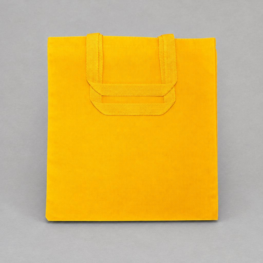 Impish Greetings yellow canvas tote bag with sturdy handles, perfect for carrying books and groceries.