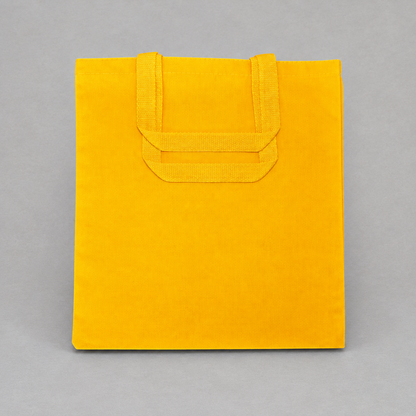 Impish Greetings yellow canvas tote bag with sturdy handles, perfect for carrying books and groceries.