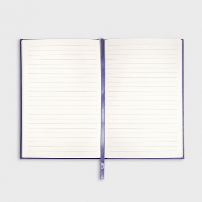 Open notebook on muted light-grey background