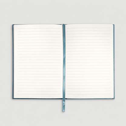 Open notebook on muted light grey