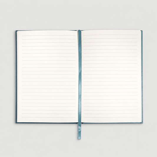 Open notebook on muted light grey