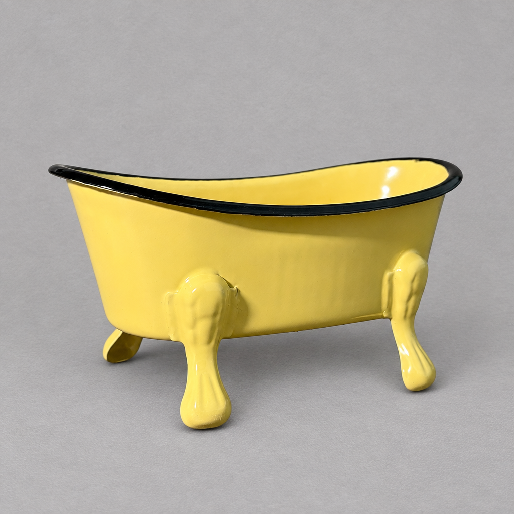 A yellow antique clawfoot soap holder with a yellow inside against a grey background