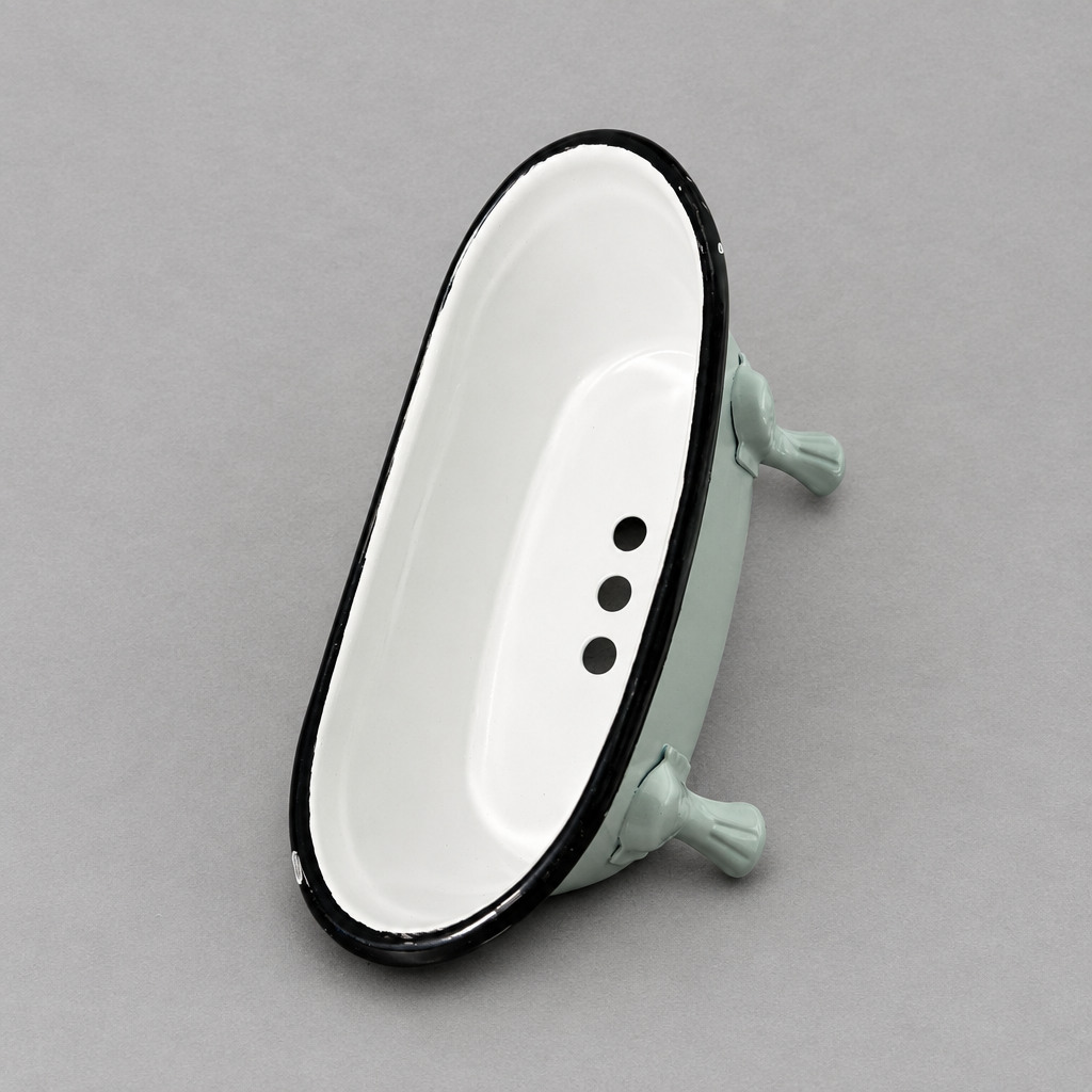 a mint green antique looking clawfoot soap holder with a white inside against a light grey background