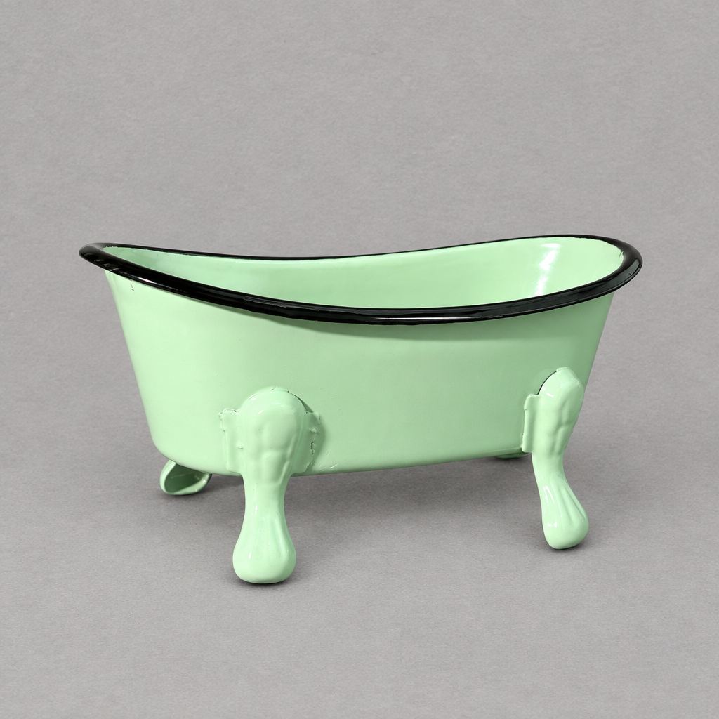 A mint green antique clawfoot soap holder with a mint color inside against a grey background