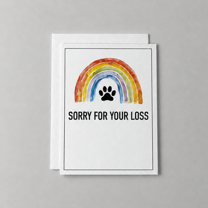 This sorry for your loss condolence card has a watercolor rainbow and paw print with the words "sorry for your loss". It is against a light grey background