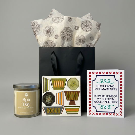 Thanks for the Booze Hostess Gift Set with unbranded black ribbon-handle bag and patterned tissue on muted light grey