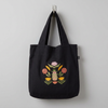 Tote hanging on a hook against a muted light-grey wall