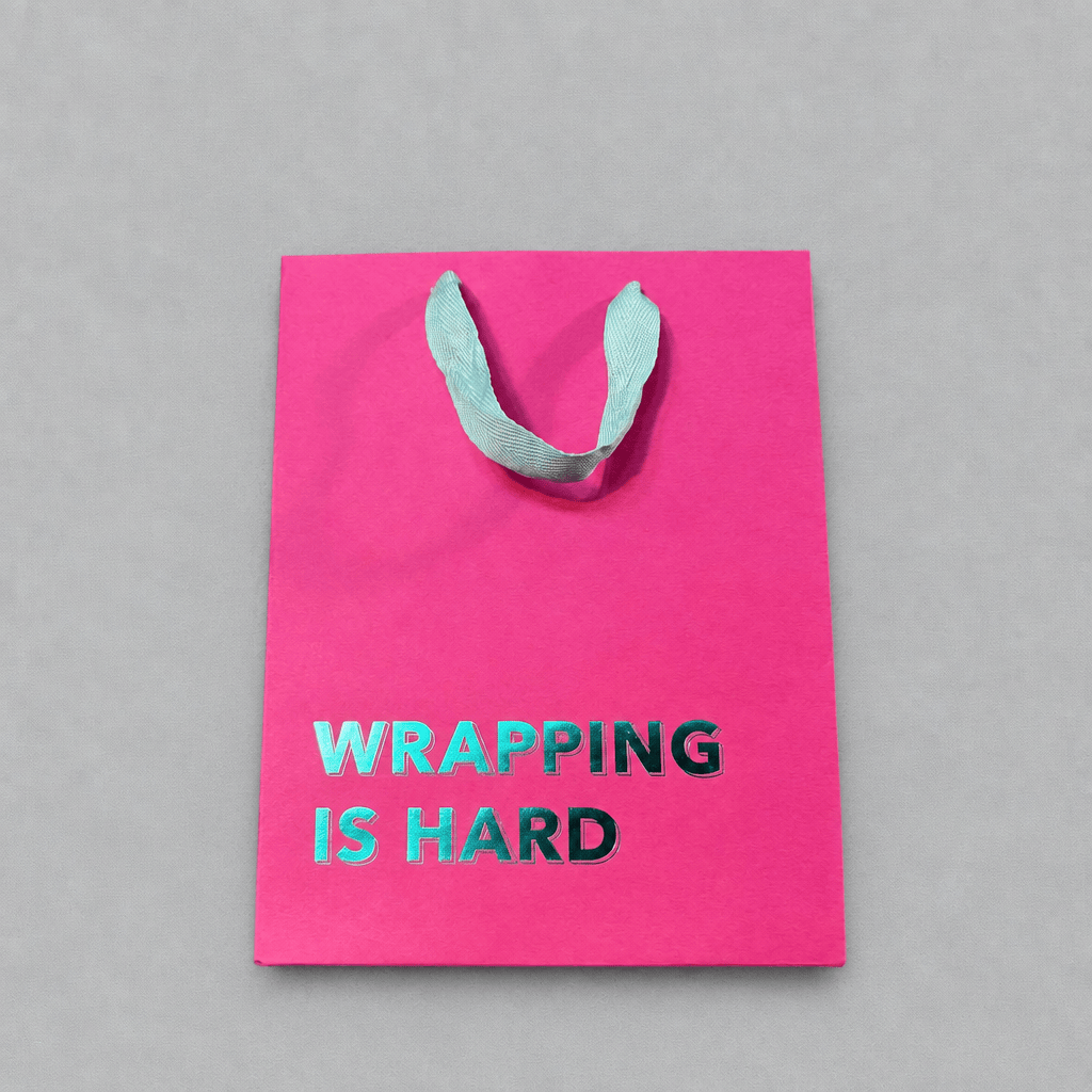 Wrapping is Hard Gift Bag Magenta photo 1 on the lighter grey backdrop