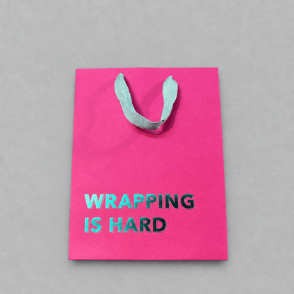 Wrapping is Hard Gift Bag Magenta photo 1 on the lighter grey backdrop
